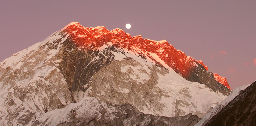 Alpenglow and moonlight: a rare celestial dance over the Himalayan giants. As the sun dips below the horizon, the peaks ignite in gold, reminding us why we journey so far into the heart of the mountains